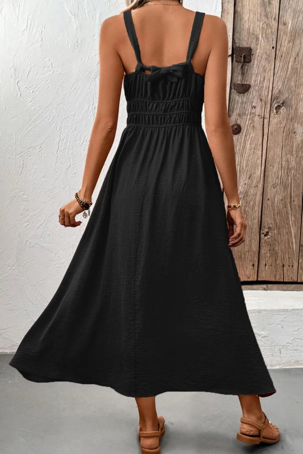 Rear view of black cami dress showing wide shoulder straps