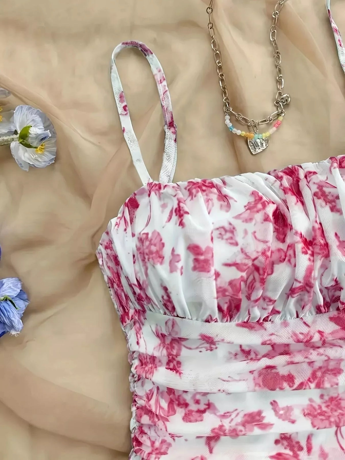 Close-up of pink floral mini dress bodice and narrow straps