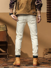 Back view of off-white slim-fit jeans with two stitched patch pockets