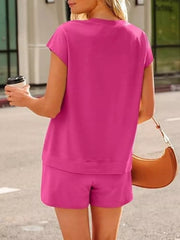Back view of the bright pink top and matching shorts.