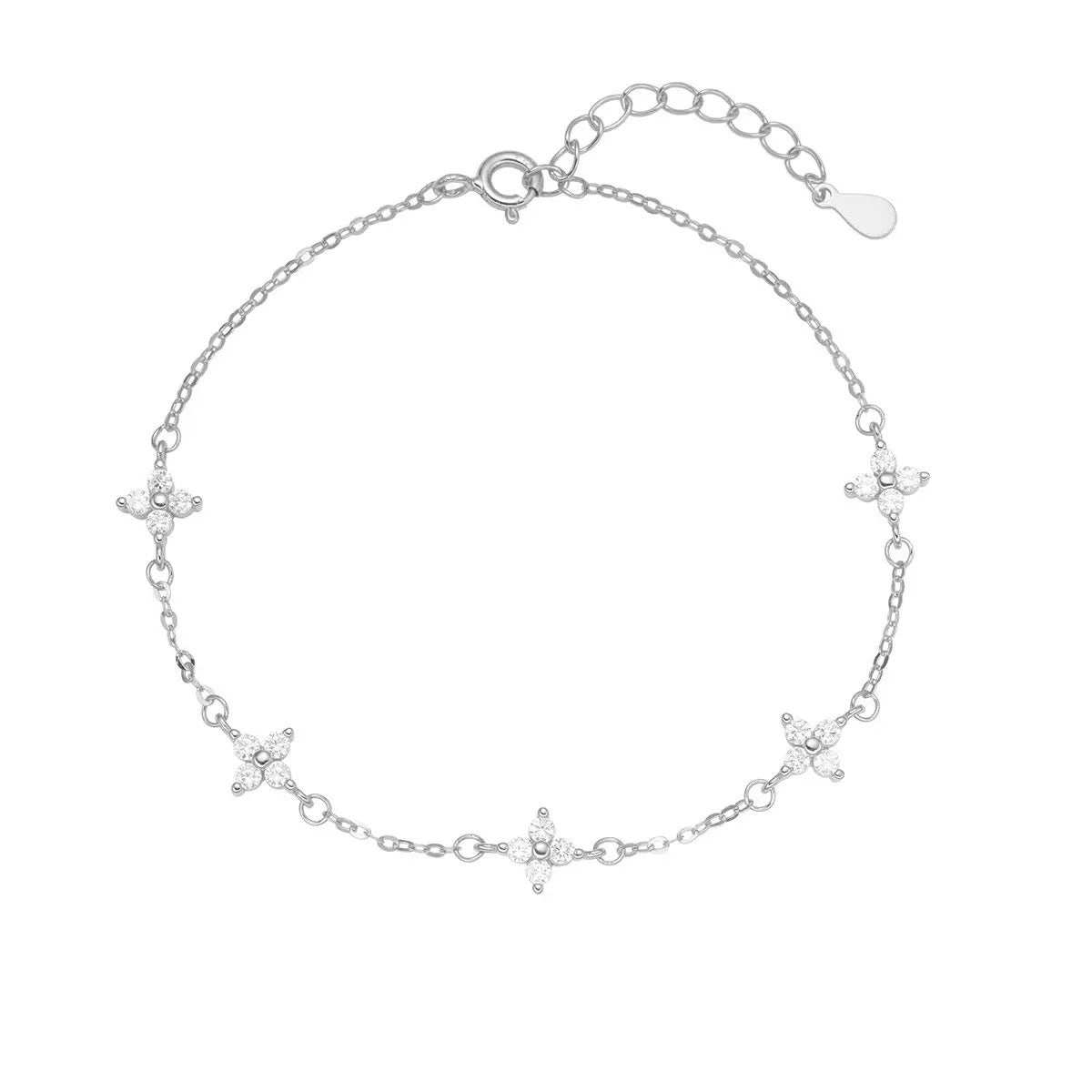 Silver four-leaf clover bracelet arranged flat with extension chain