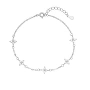 Silver four-leaf clover bracelet arranged flat with extension chain