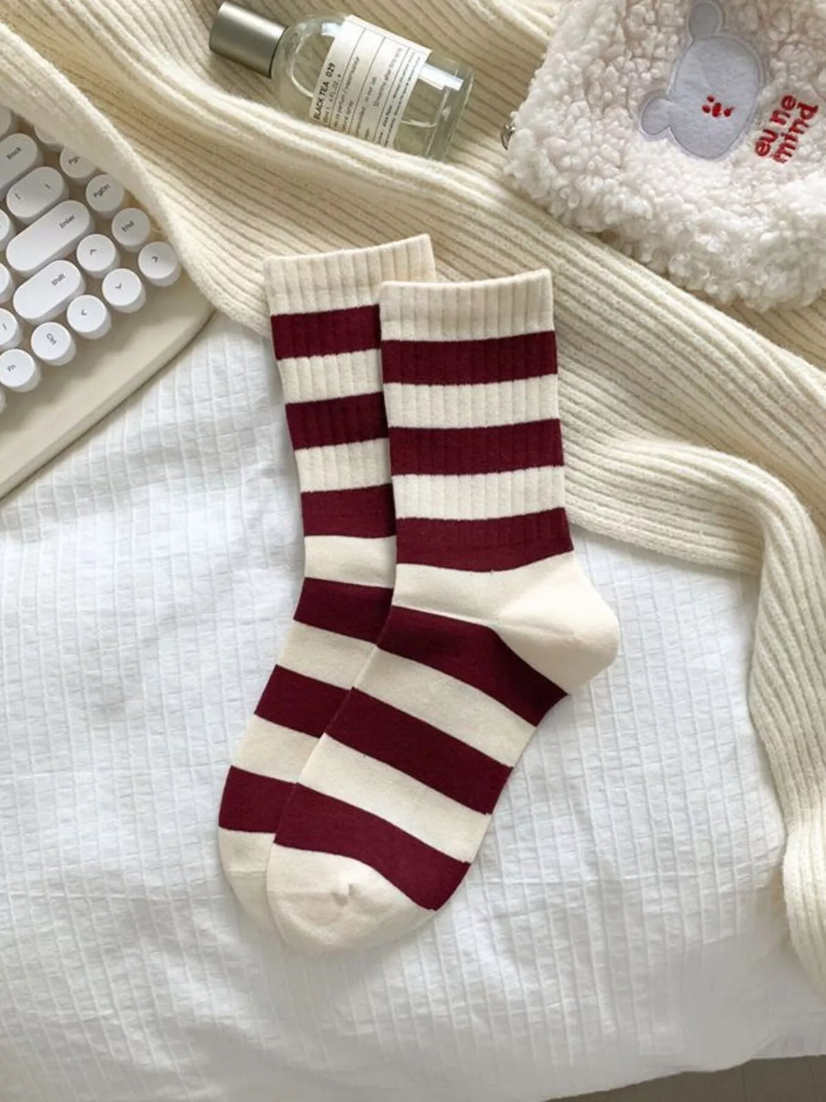 Burgundy and cream striped crew socks laid flat
