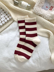 Burgundy and cream striped crew socks laid flat