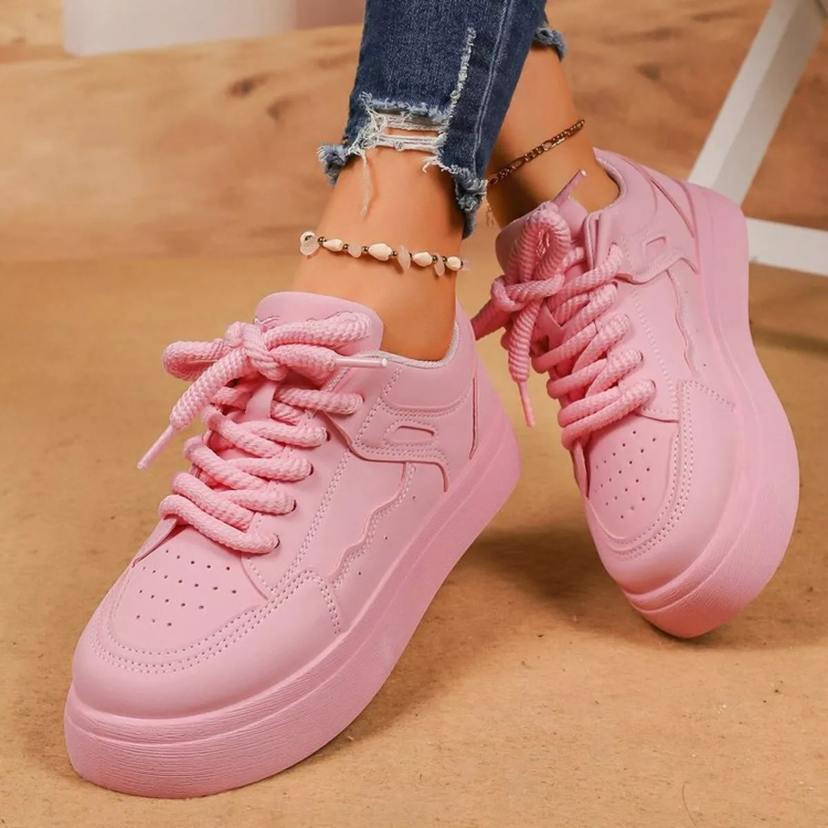 Pair of pink lace-up platform sneakers viewed from above