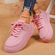 Pair of pink lace-up platform sneakers viewed from above