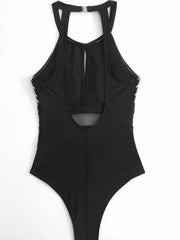 Black open-back one-piece swimsuit laid flat, back view