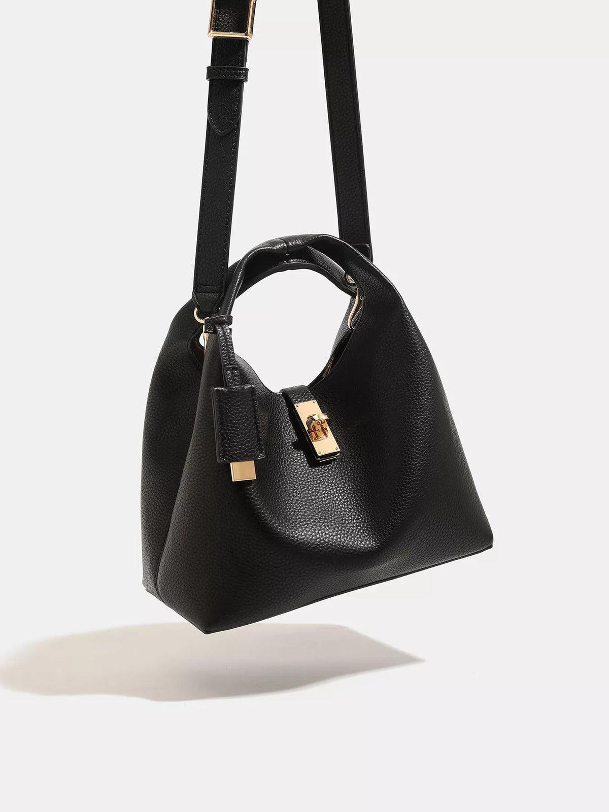 Black handbag and shoulder strap viewed from above