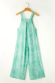 Back view of turquoise printed jumpsuit on hanger
