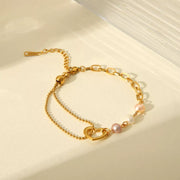 Close-up of heart charm among pearl bracelet links
