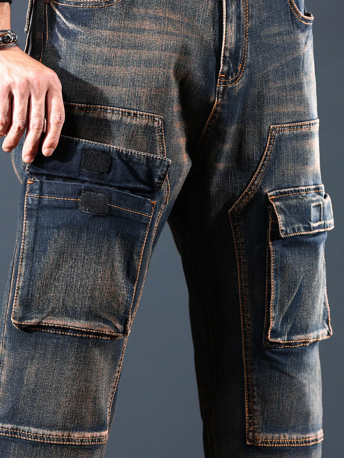 Close-up of flap cargo pockets and faded denim on the jeans