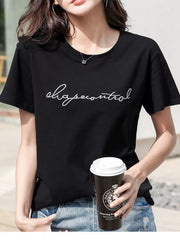 Close view of the black tee's embroidered script lettering and short sleeves