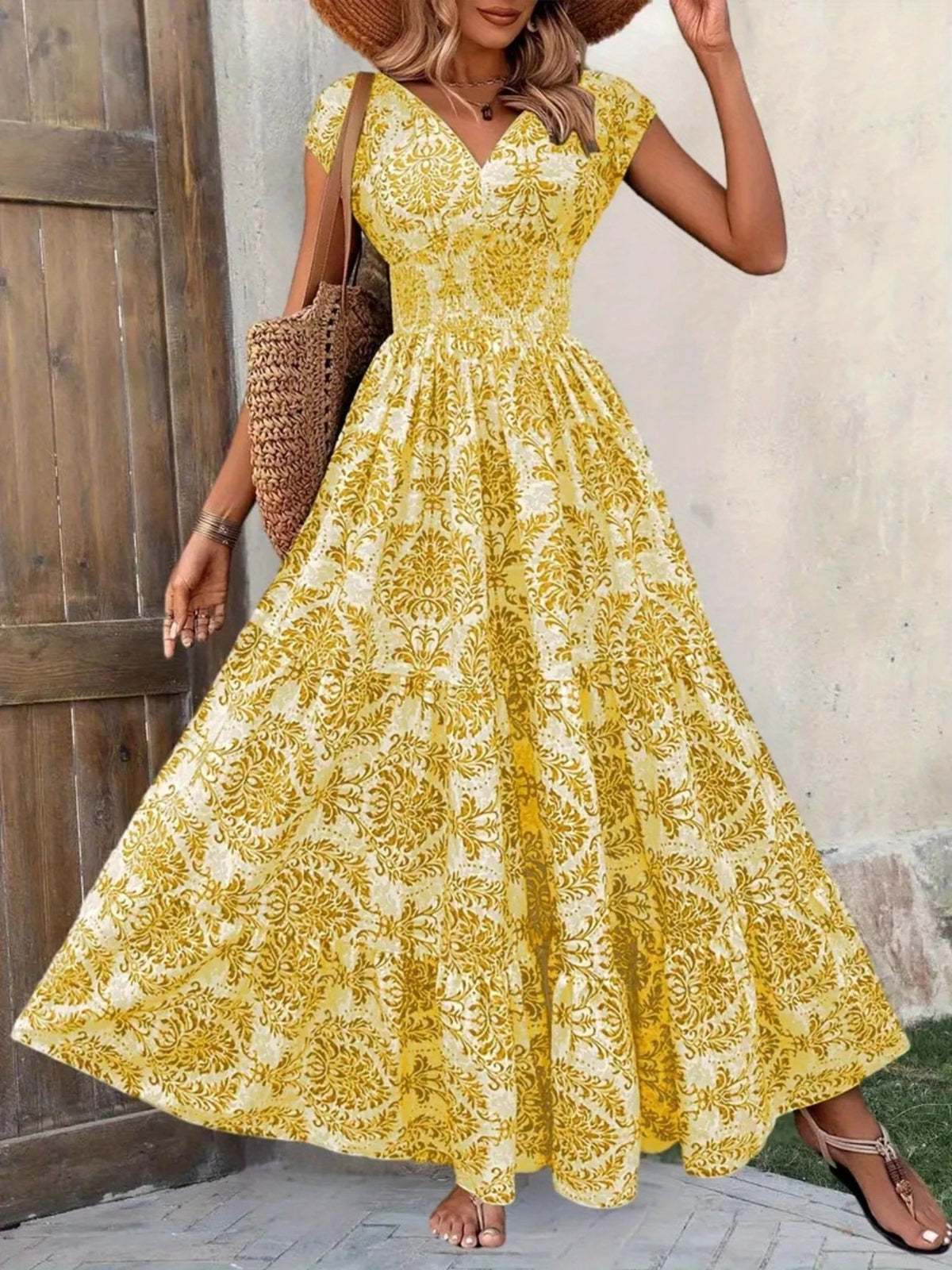 Yellow floral cap-sleeve maxi dress shown front-on with a full tiered skirt.