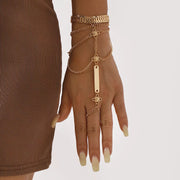 Gold-tone layered hand chain bracelet shown on a hand