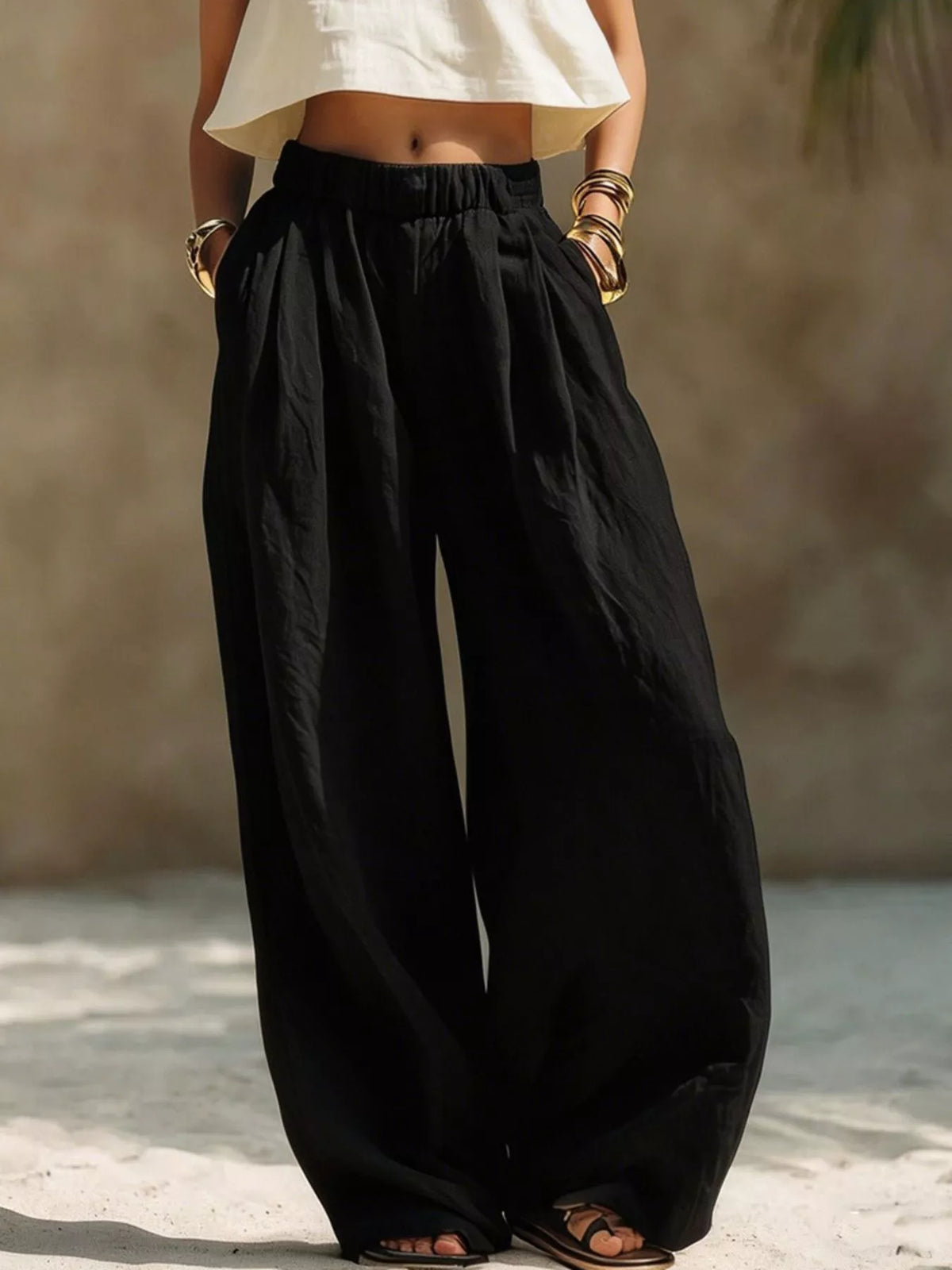 Black wide-leg pants with an elastic gathered waistband shown full length