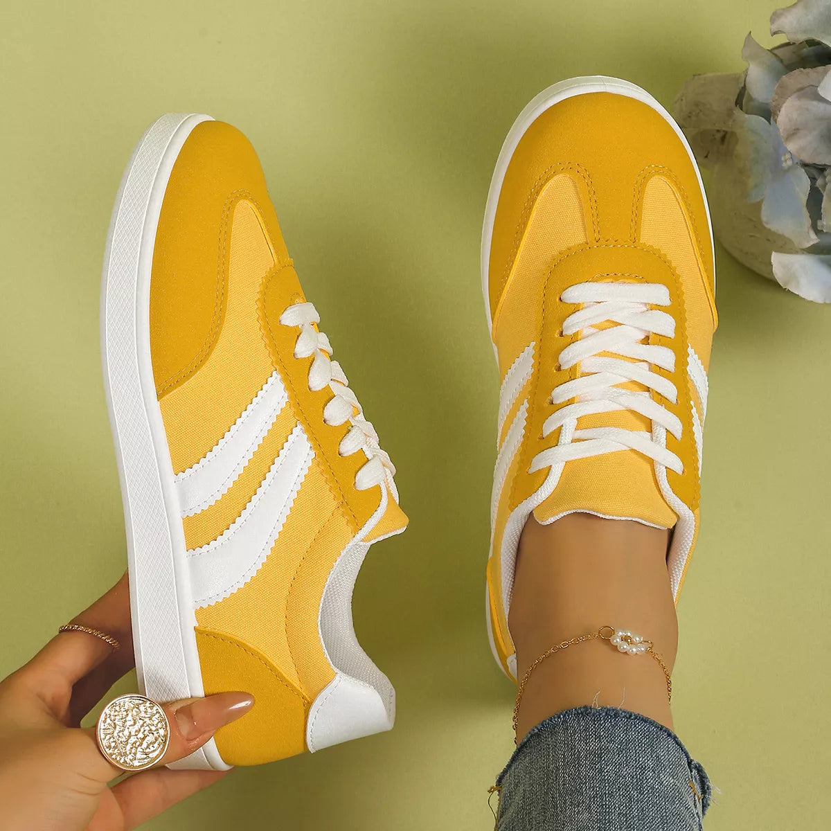 Pair of yellow flats with white stripes viewed from above