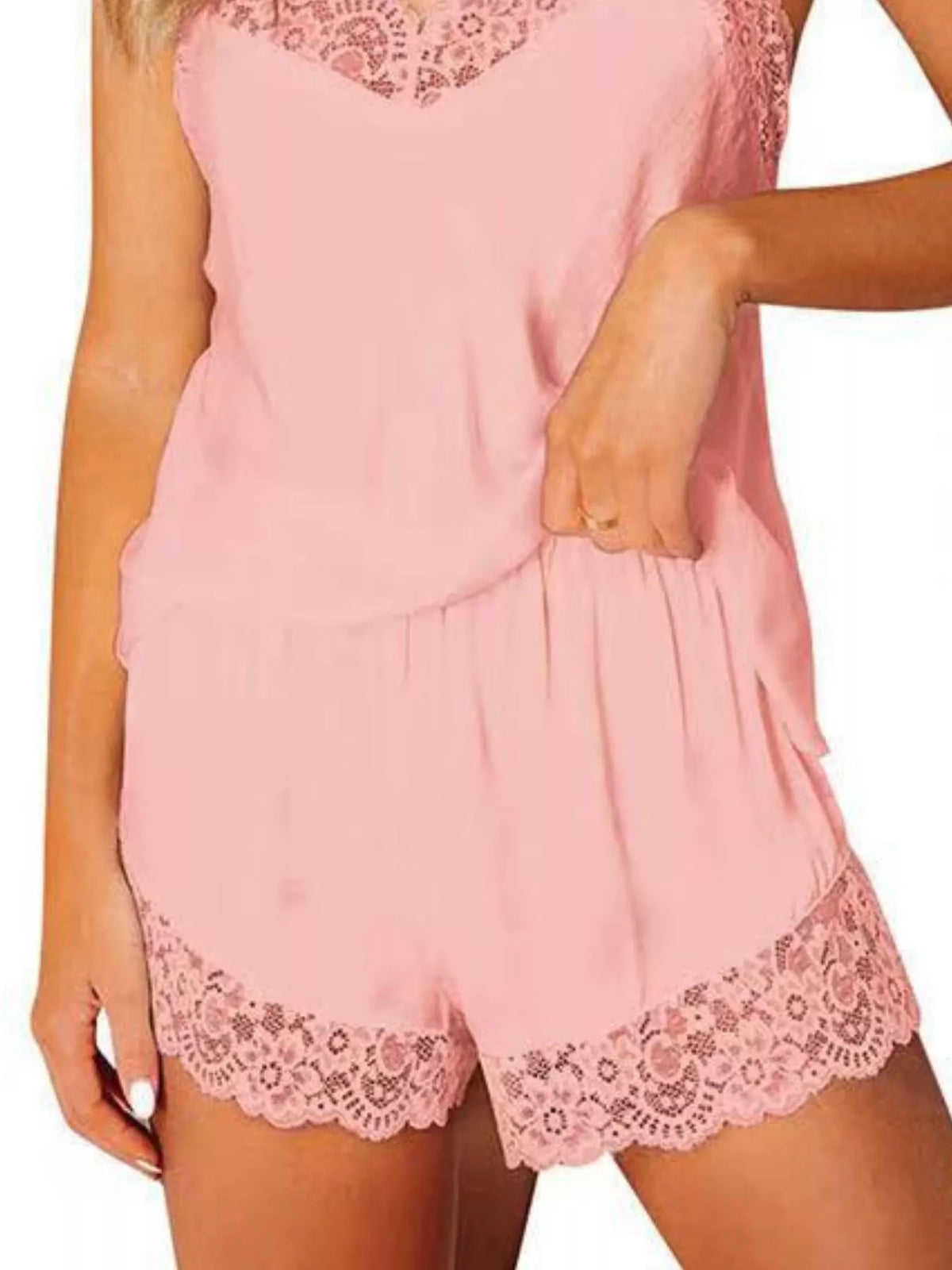 Close-up of pink shorts with a gathered waist and wide scalloped floral lace hems