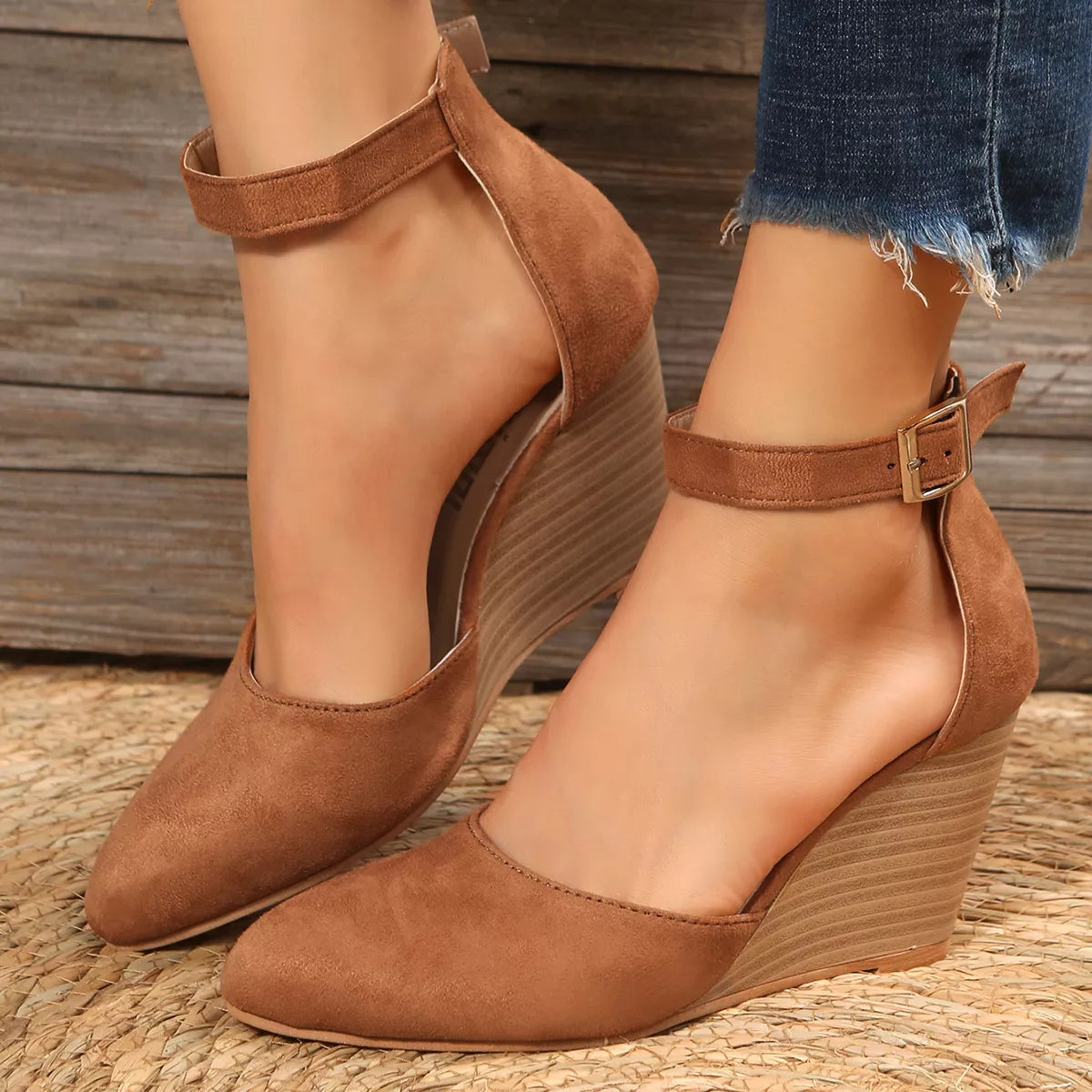 Tan pointed-toe wedge sandals shown from behind with ankle straps