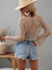 Back view of the tan openwork cropped cover-up with flared sleeves.