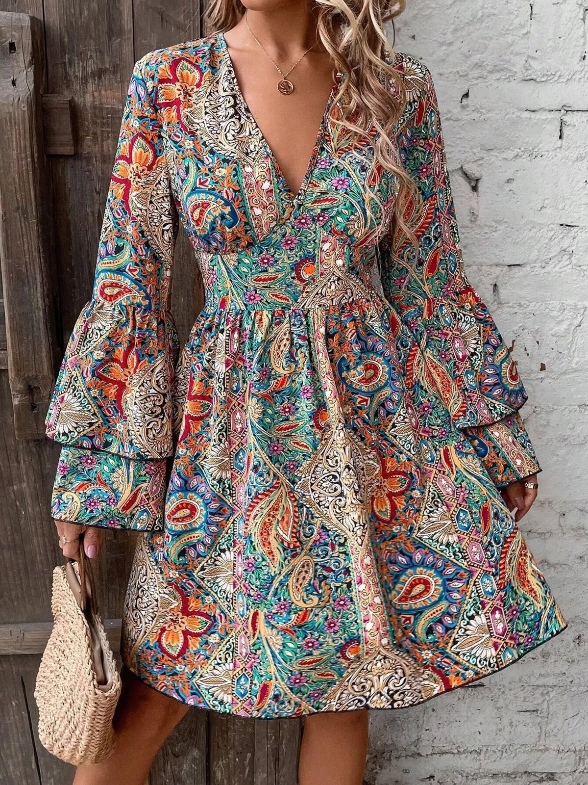 Model wearing paisley print mini dress, front view