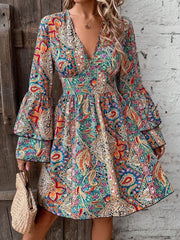 Model wearing paisley print mini dress, front view