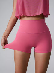 Back view of bright pink fitted shorts with a wide waistband.