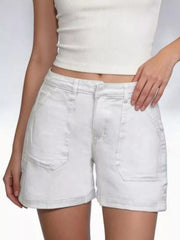 Front detail of white denim shorts with large stitched patch pockets