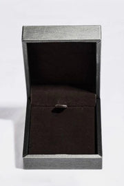 Open black jewelry box with rectangular pendant necklace inside