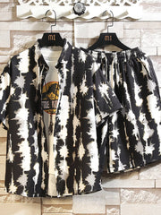 Black-and-cream abstract print button-up shirt and matching shorts set, front view