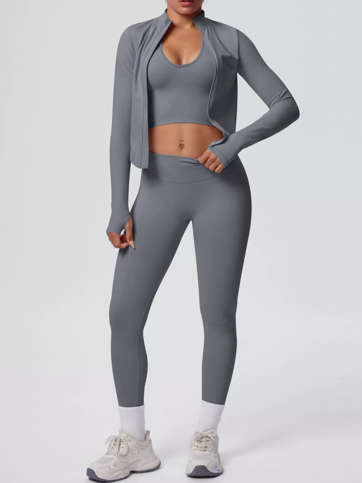 Three-quarter front view of tank & zip-up jacket and leggings three-piece active set
