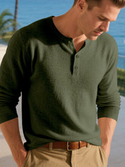 Front view of a dark green long-sleeve Henley shirt with a short button placket.