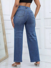 Rear view of dark blue wide-leg jeans styled with a black crop top and heels