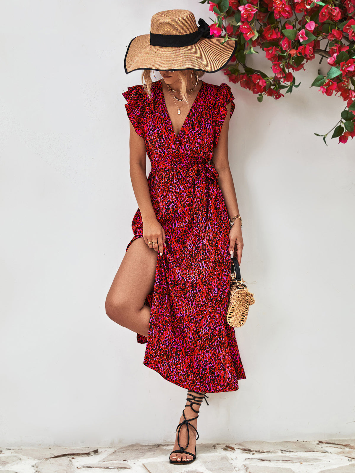 Front view of red printed V-neck dress with flutter sleeves and side slit.