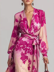 Close view of the pink floral maxi dress showing its draped V-neckline and waist bow.