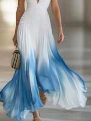 Lower view of the white and blue gradient maxi dress showing the flowing pleated hem.