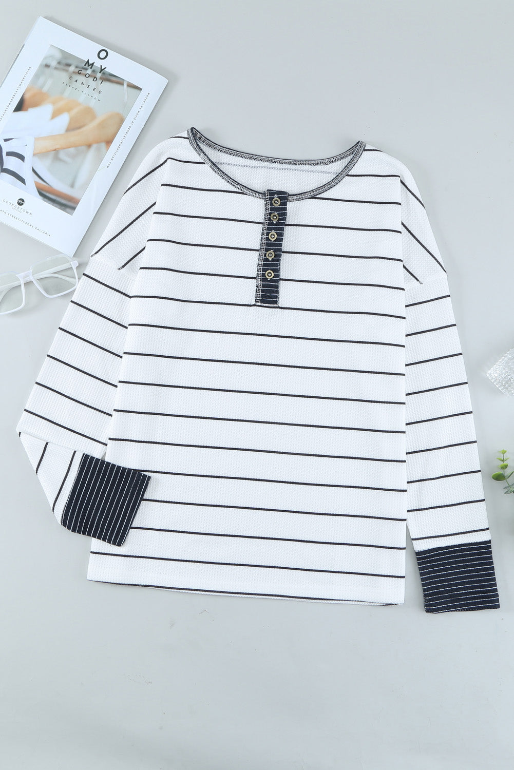 Front product view of white and black striped Henley
