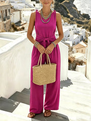 Magenta jumpsuit front view with woven handbag