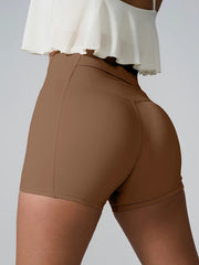 Rear view of taupe fitted active shorts with high rise.