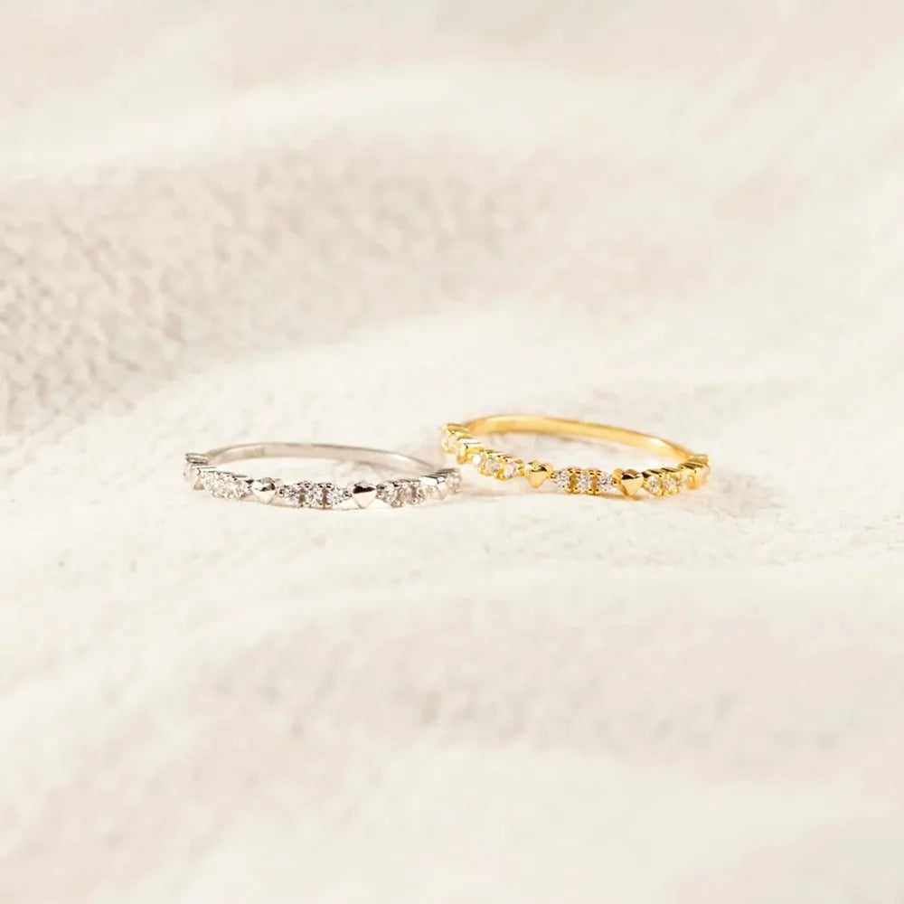 Gold-tone and silver-tone zircon bands displayed together