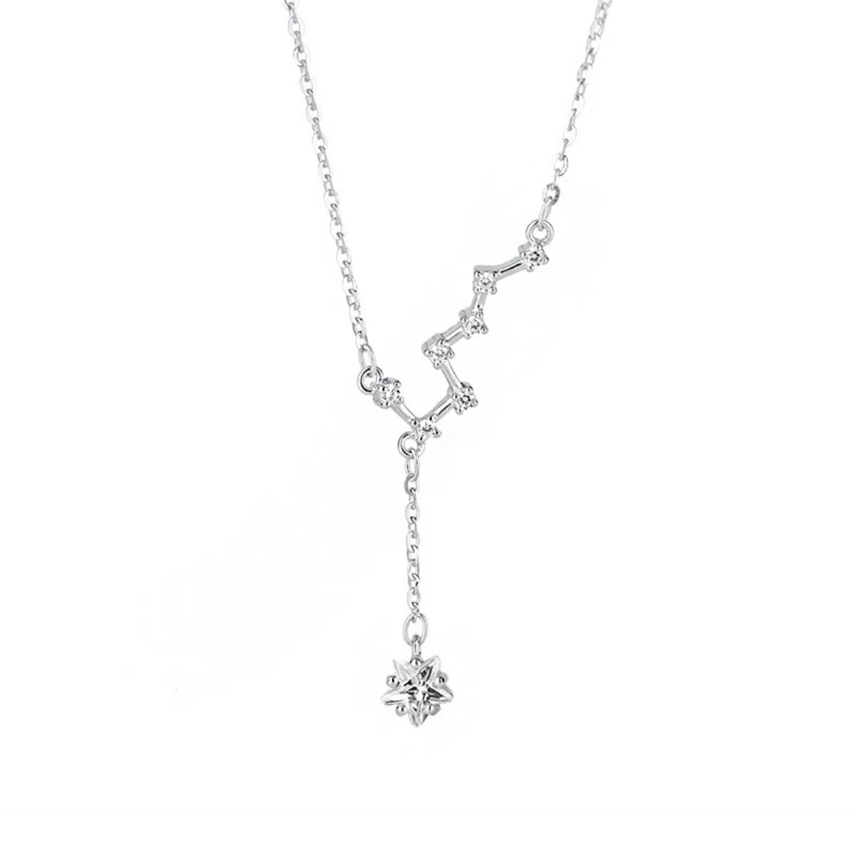 Silver star necklace with dangling star charms shown on white