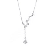 Silver star necklace with dangling star charms shown on white