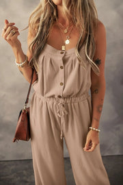 Khaki jumpsuit, close model view of button placket and drawstring waist