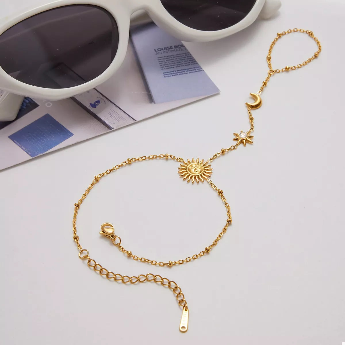 Gold sun bracelet laid flat to show its full design