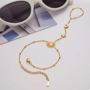 Gold sun bracelet laid flat to show its full design