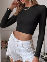 Model wearing a black ribbed long-sleeve crop top, front view