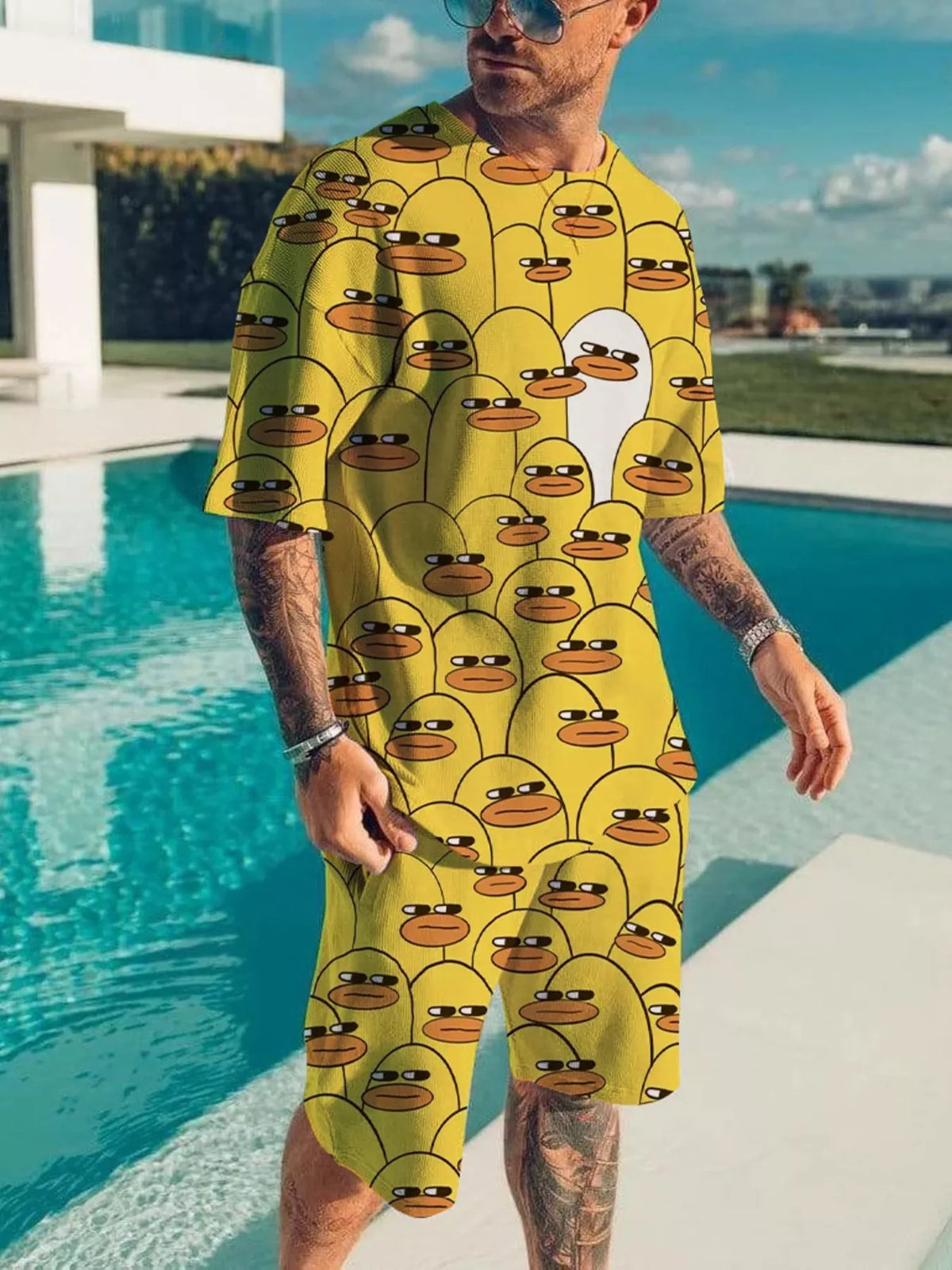 Yellow short-sleeve tee and shorts set with repeating cartoon duck faces.