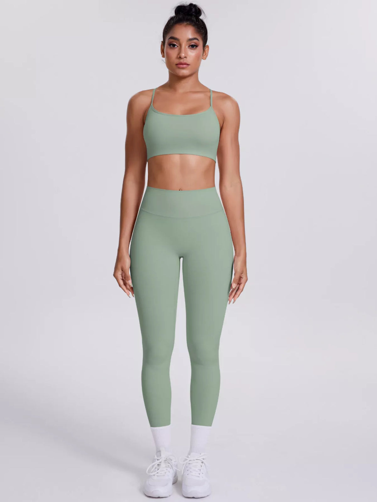 Three-quarter front view of criss-cross back cami and leggings active set