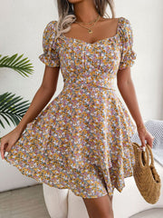 Front view of yellow floral mini dress with sweetheart neckline and flounced sleeves