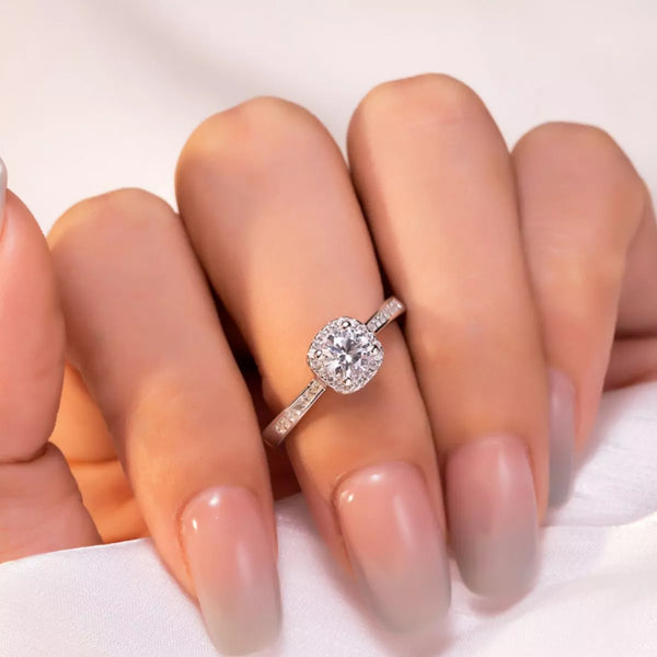 Close-up of cushion-cut moissanite ring on hand