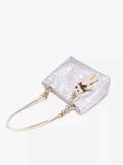 Top view of pale jacquard tote with teddy bear charm